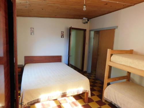 a bedroom with two bunk beds and a staircase at Arcoiris in La Coronilla