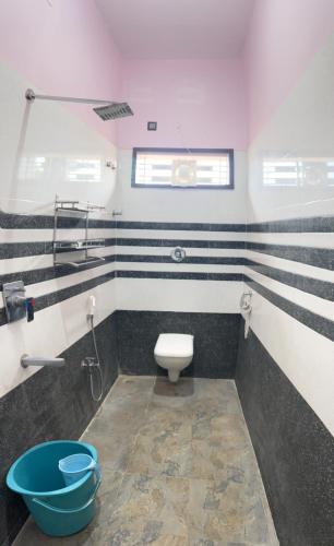 a bathroom with a toilet and a sink at Lee home stay in Hampi