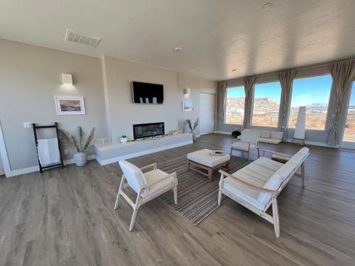 a living room with white furniture and a fireplace at Canyon Oasis suite with Grand Mesa view in Big Water