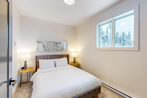 a bedroom with a bed and a window at Bear Cave- Grizzly Ridge 260A in Big White