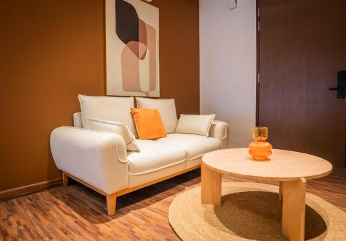 a living room with a white couch and a table at K Avenue by Pinstay in Donggongon