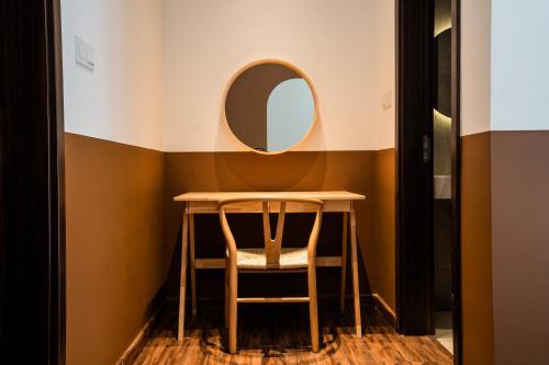 a dressing room with a table and a mirror at K Avenue by Pinstay in Donggongon