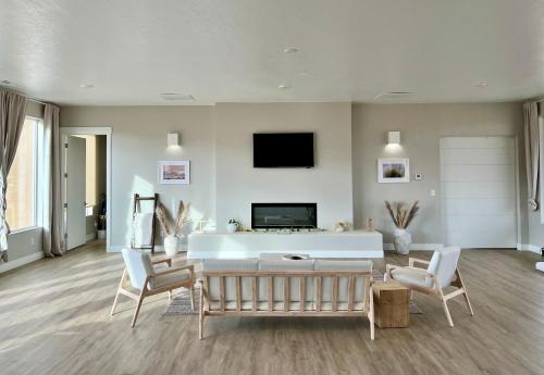 a living room with a couch and a tv at Canyon Oasis suite with Grand Mesa view in Big Water