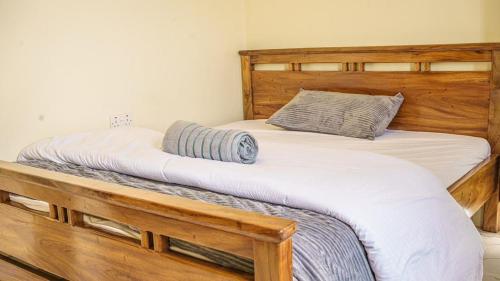 two twin beds in a bedroom with a wooden frame at Serene villa in Jinja