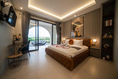 a bedroom with a large bed and a balcony at Alsava Villa and Suites Canggu in Canggu