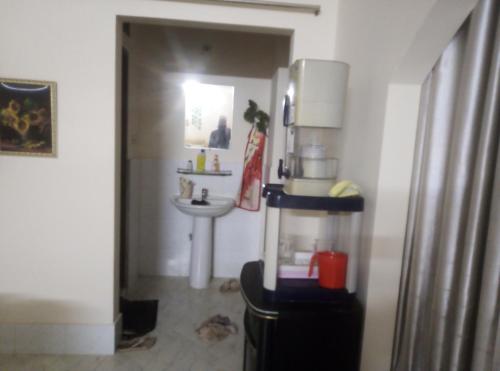 a kitchen with a sink and a refrigerator at Rent Room in Bashundhara R A near US Embassy in Dhaka