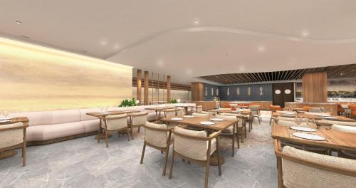 a restaurant with tables and chairs and a couch at WM Hotel Hong Kong, Vignette Collection in Hong Kong