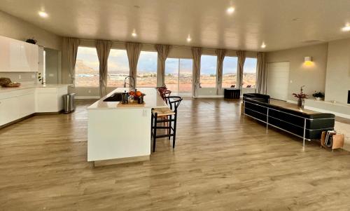 a kitchen with white cabinets and a counter top at Page Arizona border town- Grand Serenity room with Mesa Views in Big Water
