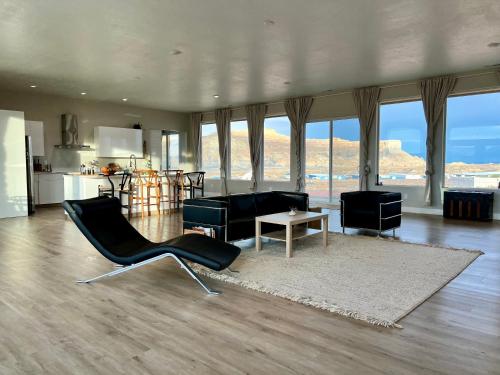 a living room with black chairs and a table at Page Arizona border town- Grand Serenity room with Mesa Views in Big Water