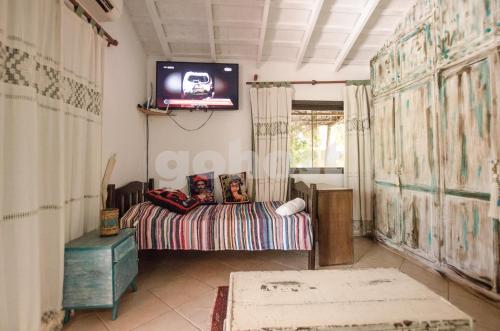 a bedroom with a bed and a tv on the wall at Comfortable And Spacious House In San Bernardino in San Bernardino