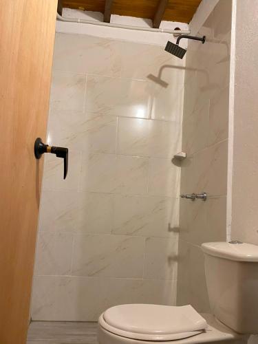 a bathroom with a toilet and a shower at ApartaLoft Carolina in Carolina del Principe