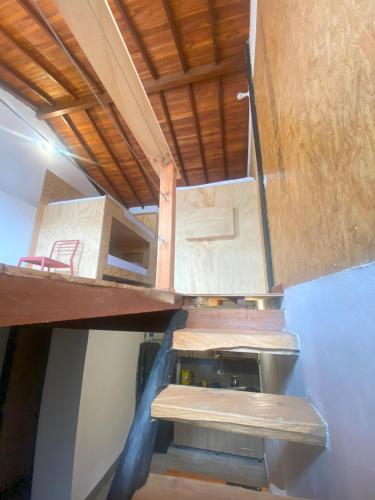 a room with a staircase in a tiny house at ApartaLoft Carolina in Carolina del Principe