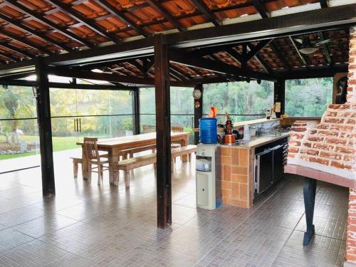 - une cuisine et un coin repas dans un pavillon dans l'établissement Sítio Encantador na Cidade de Jarinu, à Jarinu
