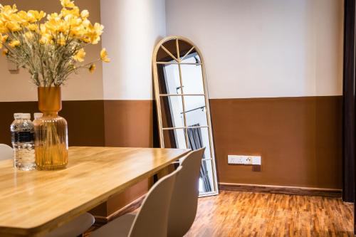 a dining room with a table and a mirror at K Avenue by Pinstay in Donggongon