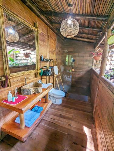 a bathroom with a sink and a toilet at Yogachal Vista Mar Bamboo House in the Jungle in Ojochal
