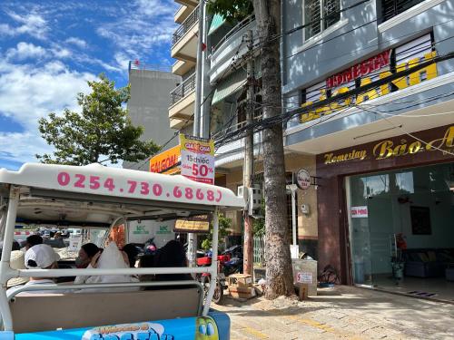 a street scene with a bus in front of a store at Homestay Bảo Anh in Vung Tau