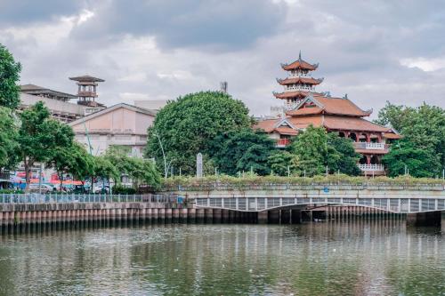 a large building with towers next to a river at Jomo in Ho Chi Minh City