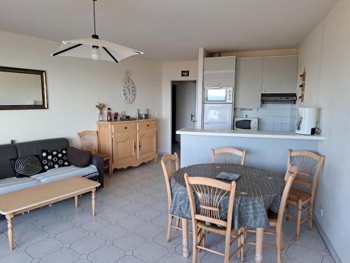 une cuisine et un salon avec une table et des chaises dans l'établissement Appartement spacieux 5 pers, front de mer, centre animations, balcon, animaux admis - FR-1-323-485, à Saint-Jean-de-Monts