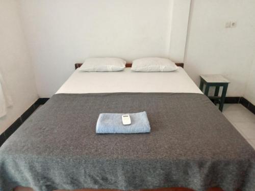 a bed in a room with a tray on it at bulan homestay in Plambi