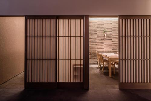 a dining room with a table and a dining roomasteryasteryasteryasteryasteryastery at MUWA NISEKO in Kutchan