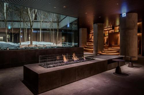 a lobby with a fire pit in the middle at MUWA NISEKO in Kutchan