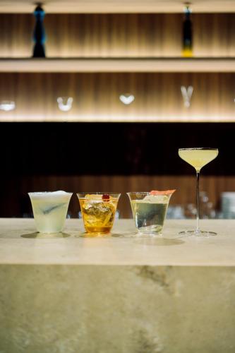 a group of four bowls and a wine glass on a counter at MUWA NISEKO in Kutchan