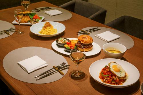 a wooden table with plates of food on it at MUWA NISEKO in Kutchan