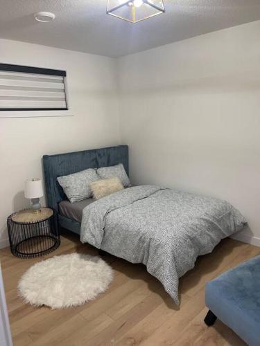 a bedroom with a bed and a couch at Modern 2Bedroom suite in SW Edmonton close to Edmonton International Airport in Edmonton