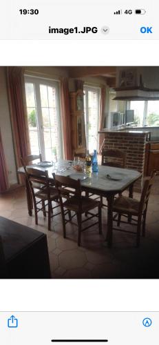 a dining room with a table and some chairs at Ferme d’Herlaimont in Chapelle-lez-Herlaimont