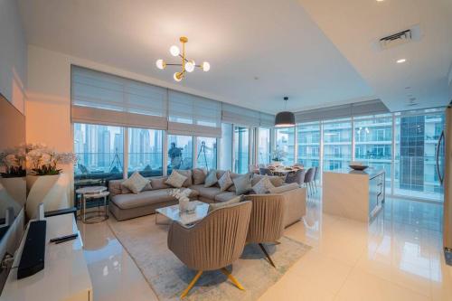 a living room with a couch and a table at FIRST CLASS 3BR with Dubai Marina & Palm View in Dubai