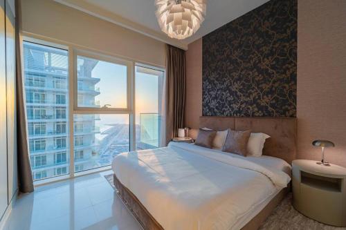 a bedroom with a large bed and a large window at FIRST CLASS 3BR with Dubai Marina & Palm View in Dubai