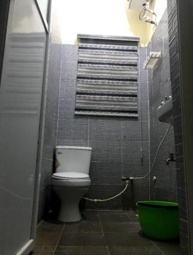 a bathroom with a white toilet in a room at F&B Service Apartment in Abeokuta