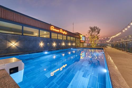a large swimming pool in front of a building at Bcons PS Hotel and Apartment- Newly Opened Hotel in Bien Hoa