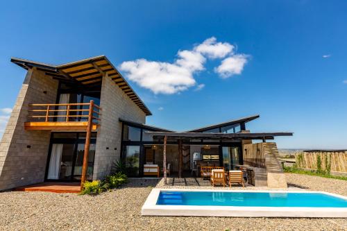 a house with a swimming pool in front of it at Casa Macondo - Casa de playa en Vichayito by WiroHouse in Vichayito