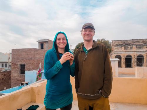a man and a woman standing on top of a building at m.i. guest house in Bikaner