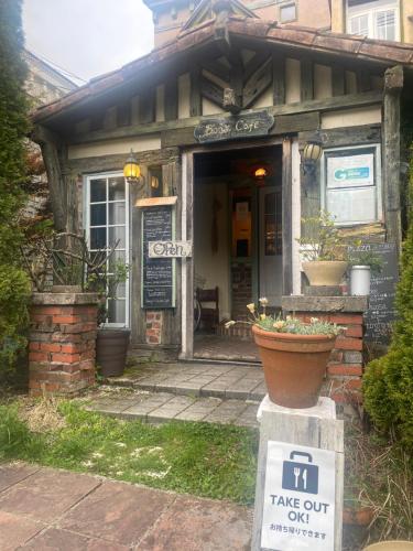 a house with a sign in front of it at Casa Allegra in Yamanakako