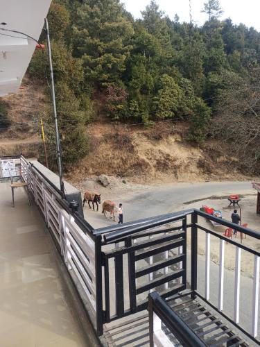 a group of people and animals standing on a bridge at Shivalik guest house in Dhanaulti