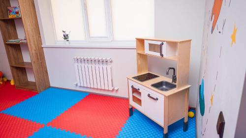 a toy kitchen with a sink and a counter at Eco hotel & restaurant "SKALA" in Borovoye
