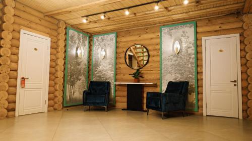 a room with two chairs and a table with a mirror at Eco hotel & restaurant "SKALA" in Borovoye