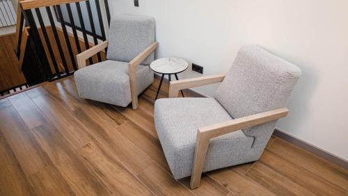 a living room with two chairs and a table at Eco hotel & restaurant "SKALA" in Borovoye