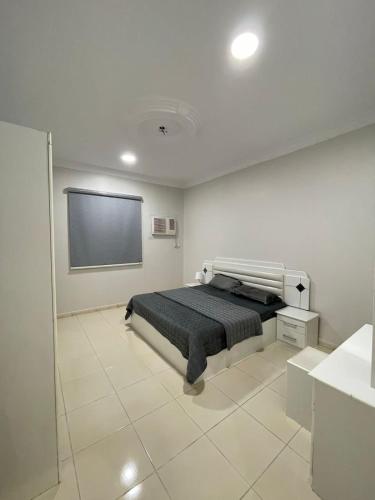 a bedroom with a bed and a flat screen tv at مرفق هجرة السياحي الخاص in Al Madinah