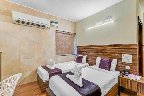 a hotel room with two beds and a window at Season 4 Residences - Nungambakkam Near US consulate, Apollo Hospital, Shankar Nethralaya in Chennai
