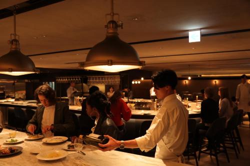 a man is preparing food at a restaurant at NOHGA HOTEL KIYOMIZU KYOTO in Kyoto