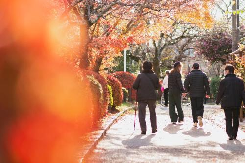 a group of people walking down a sidewalk at NOHGA HOTEL KIYOMIZU KYOTO in Kyoto