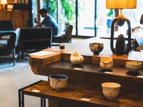a table with vases and a lamp on it at NOHGA HOTEL KIYOMIZU KYOTO in Kyoto