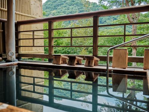 a view of the water from a balcony of a building at Hatago Kintoen in Hakone