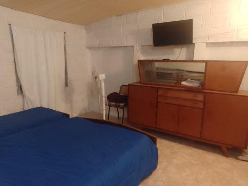 Ένα ή περισσότερα κρεβάτια σε δωμάτιο στο Hospedaje BellaVilla