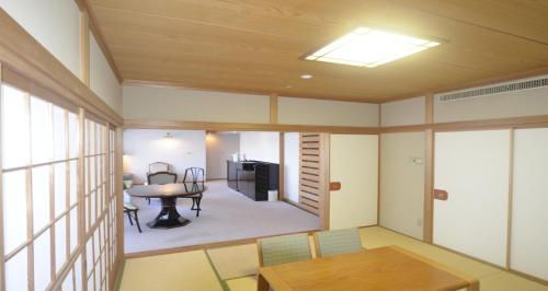 a living room with a table and a dining room at Resol no Mori in Nagara