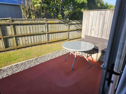 a table and a bench on a patio at Gateway Motor Inn in Masterton