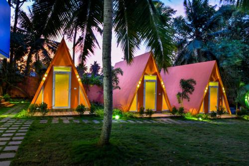 a house with a pink and orange facade at GoGo Land Resort & Adventurous Sports in Pūvār